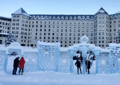 Group of people in colorful jackets posing playfully on a street with mountain backdrop.