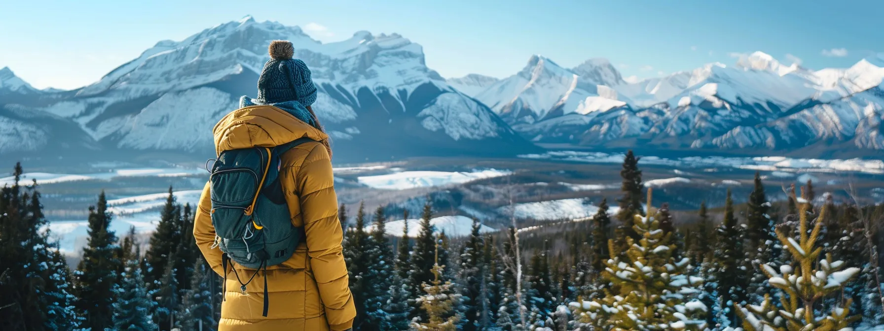 a breathtaking winter landscape in banff, showcasing snow-covered mountains under a clear blue sky, with a well-equipped traveler dressed in layered, versatile clothing, ready for a day of outdoor adventure.